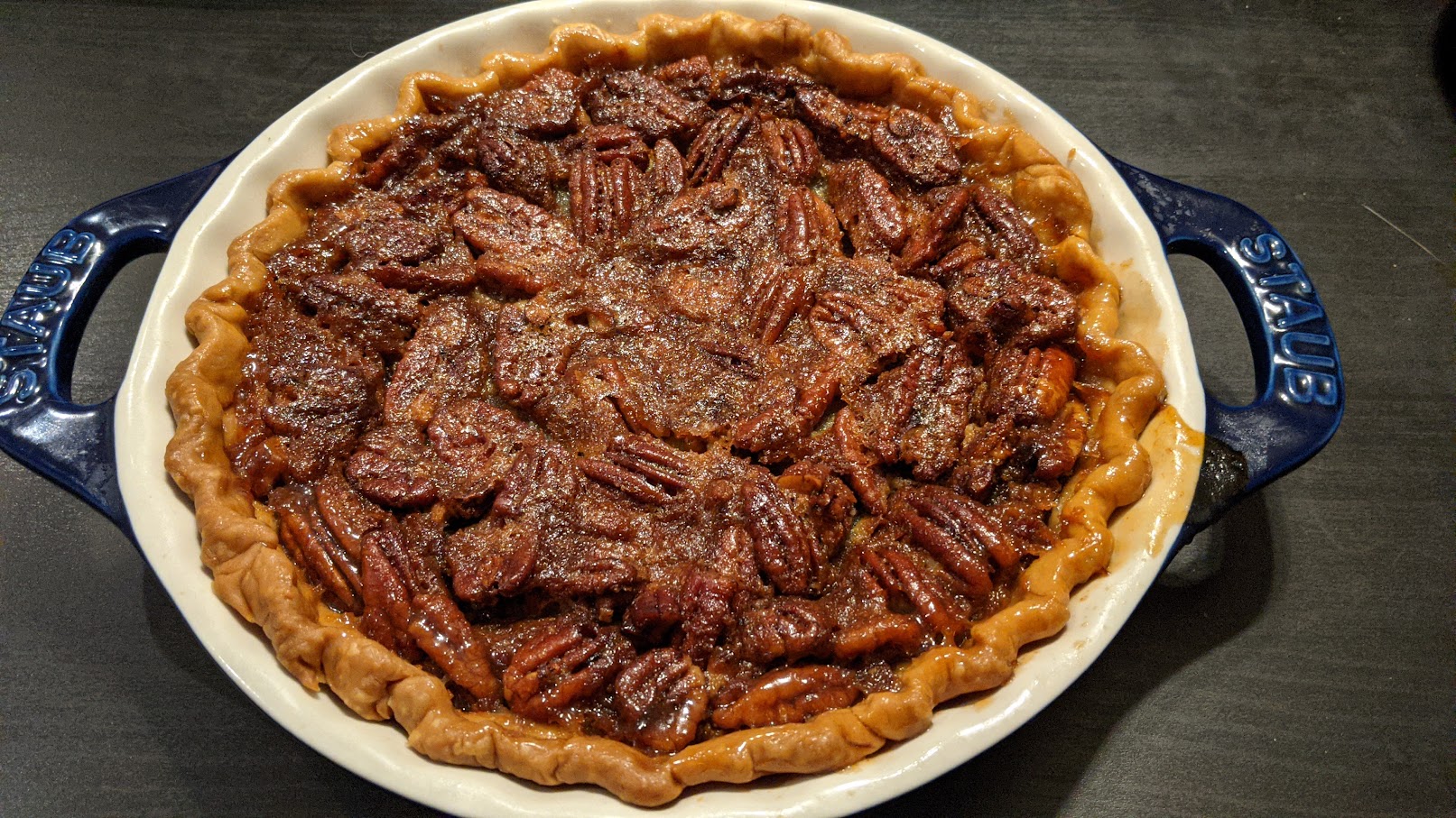 photo of a pecan pie in a blue staub pie pan